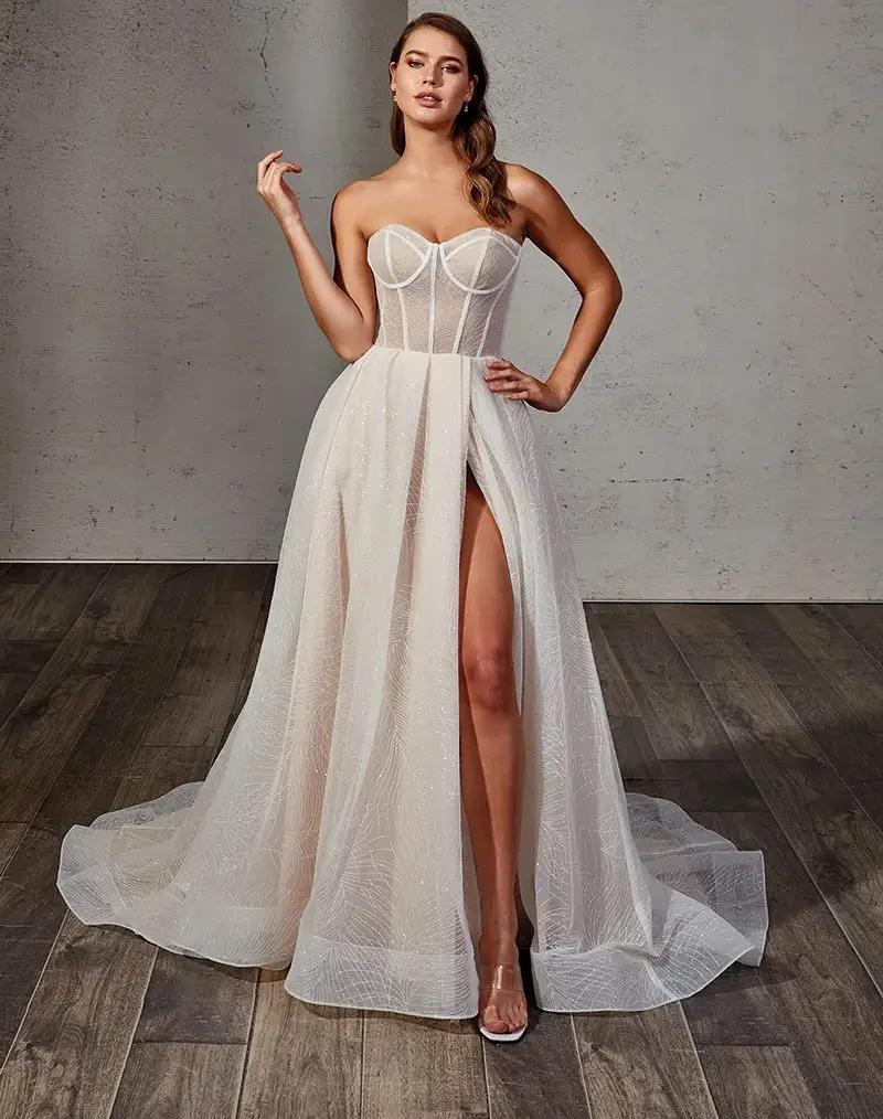 Model wearing a white gown by Eddy K