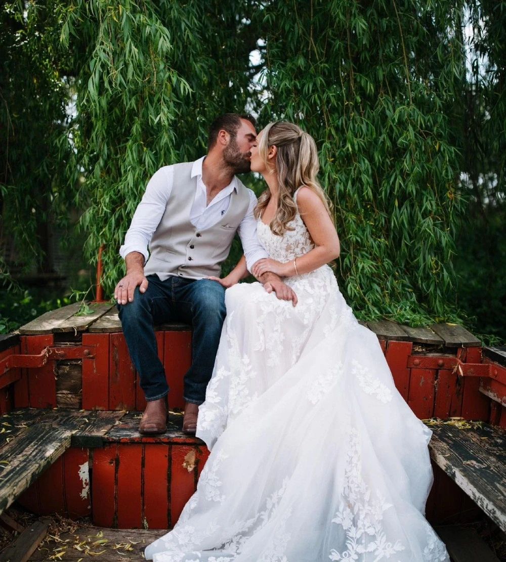 Сouple wearing a white gown and a black suit